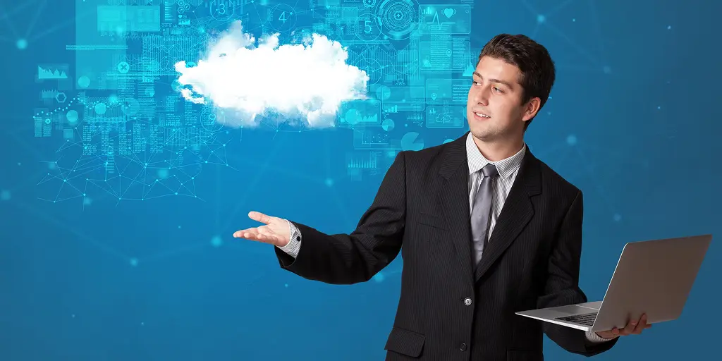 A man in a suit holds a laptop, pointing to a cloud, symbolizing Salesforce Opportunity Stages in a business context.