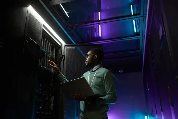 A data center engineer is conducting a manual inspection of the space and server rack.