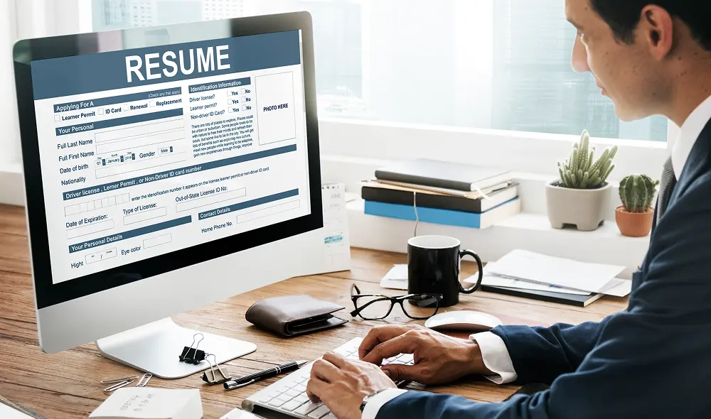 A HR professional going through the resume on a computer monitor for the recruitment process