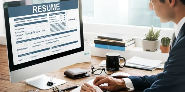 A HR professional going through the resume on a computer monitor for the recruitment process